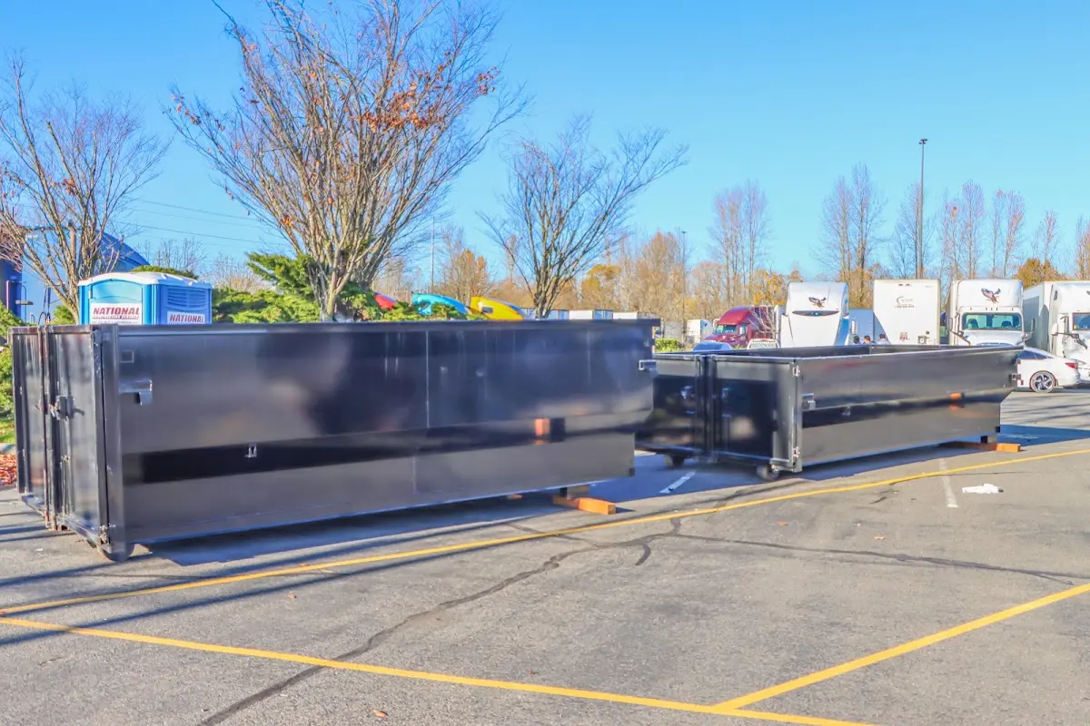 Professional dumpster rental service with roll-off container on residential driveway in Winslow